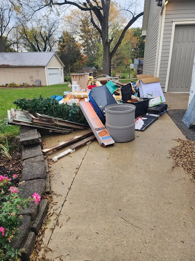 Dumpster being loaded with debris for Estate Cleanout Dumpster Rental in Grand Island